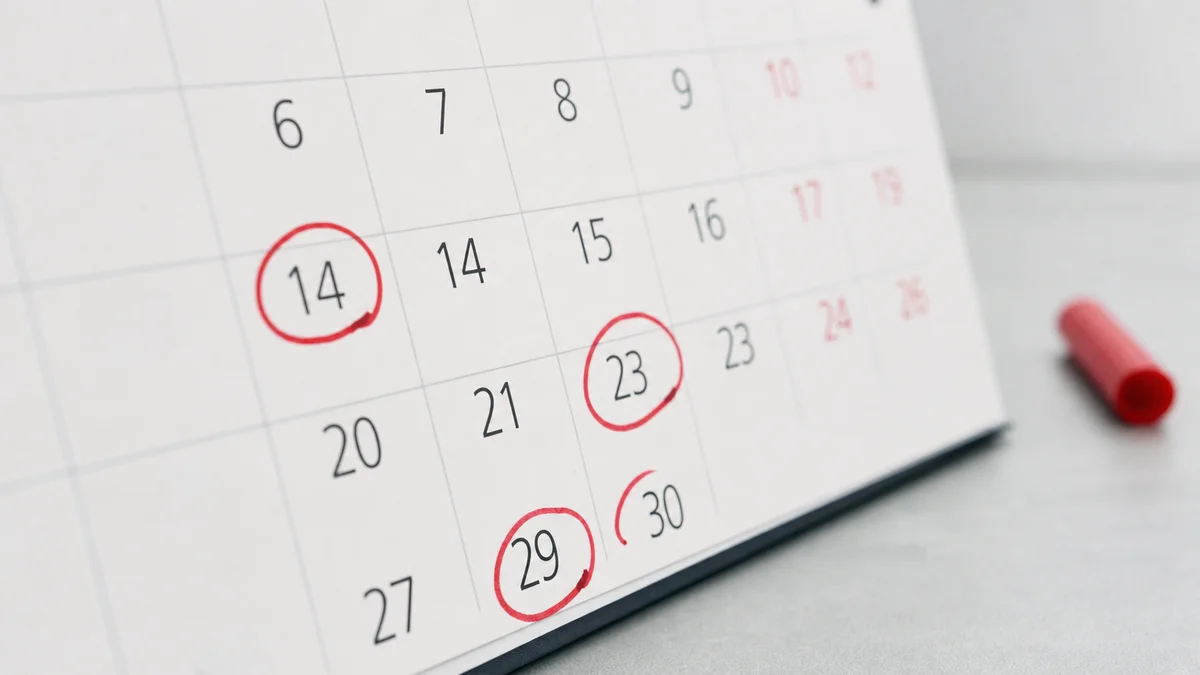 Macro close-up of a desk calendar with a 90-day interval circled in red ballpoint pen